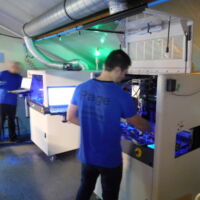 Al méér dan 10 jaar vernissen we bestukte printen, we hebben een groep van 8 ervaren medewerkers. We hebben 2 recente Nordson Asymptec sl 940 (double head filmcoater + naald) vernisrobots, we proberen zoveel mogelijk Acryl vernis van Peters Lackwerke te gebruiken. Bemerk de fluorescerende pigment in de vernis, dit dient voor visuele inspectie. Richtprijs: halve euro per samenstelling + 0.3 €/dm² voor vlakke zijde, en + 0.4 tot 0.7€/dm² comp. zijde